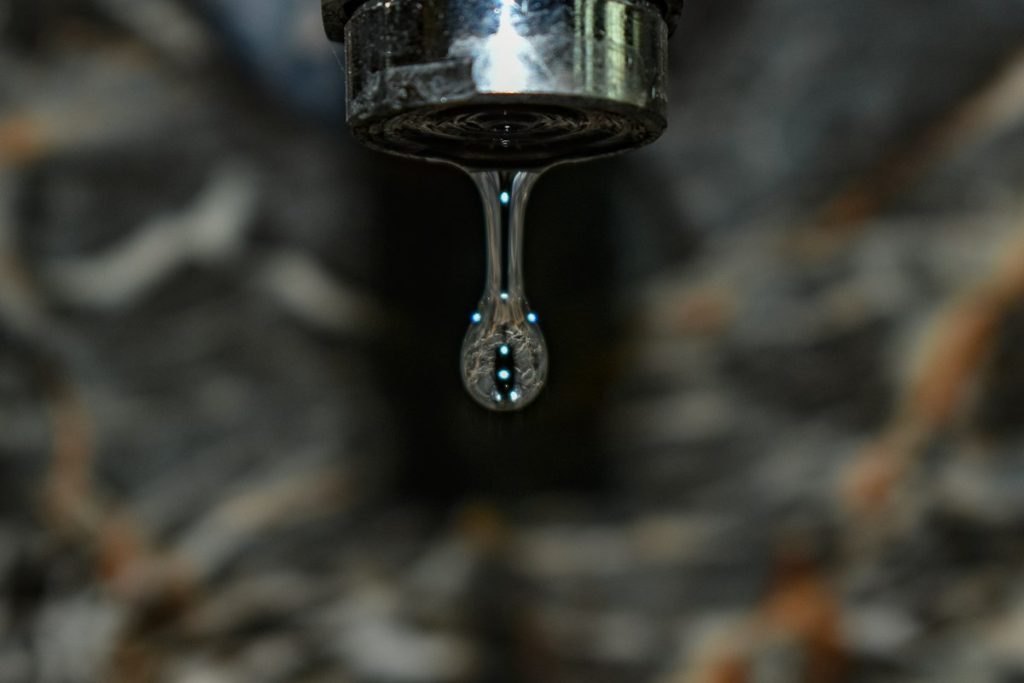 Faucet leaking a steady line of water drops