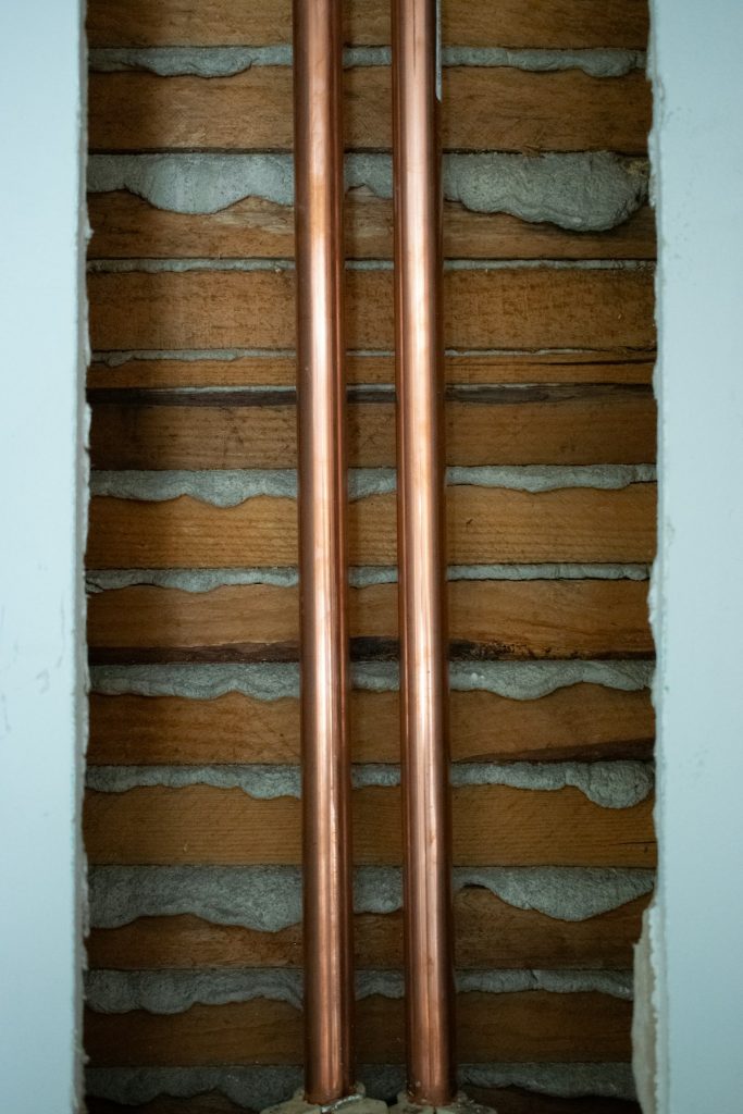 New copper water pipes installed along a wall
