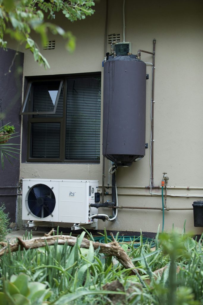 Residential water heater mounted on an exterior wall