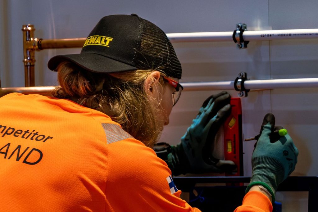 Technician aligning pipe sections before sealing
